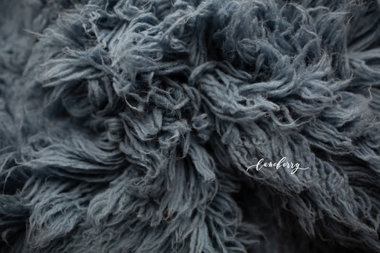 smokey blue flokati rug - a mixture of grey and blue hues on a wool rug for newborn posing
